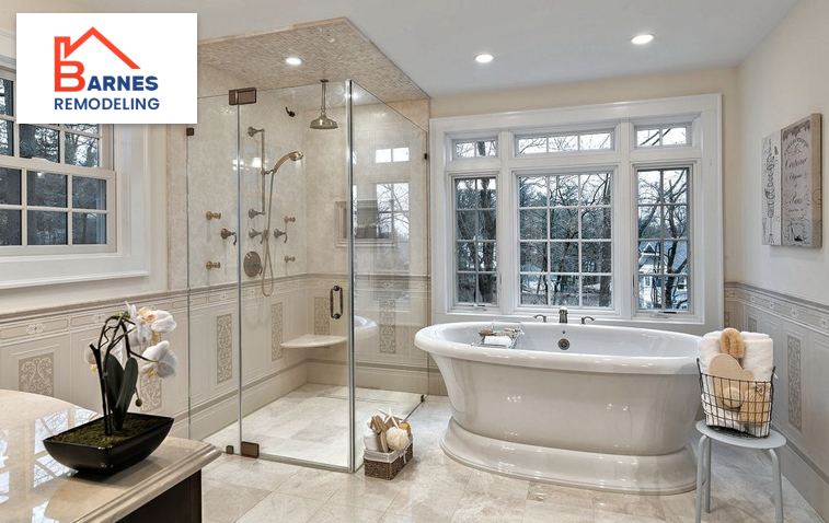 Bathroom featuring grab bars, a walk-in shower, and a raised toilet for accessibility